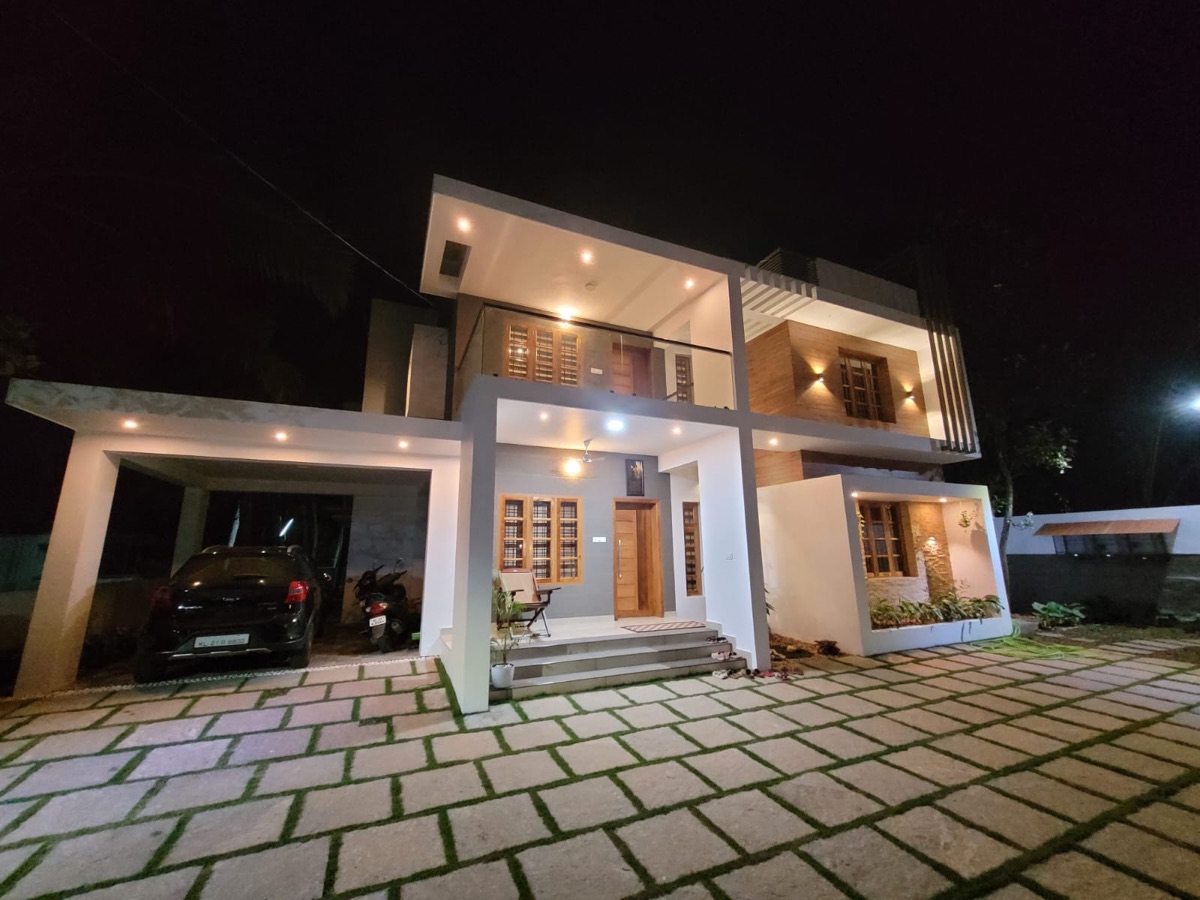 Night elevation of finished home with landscaped driveway