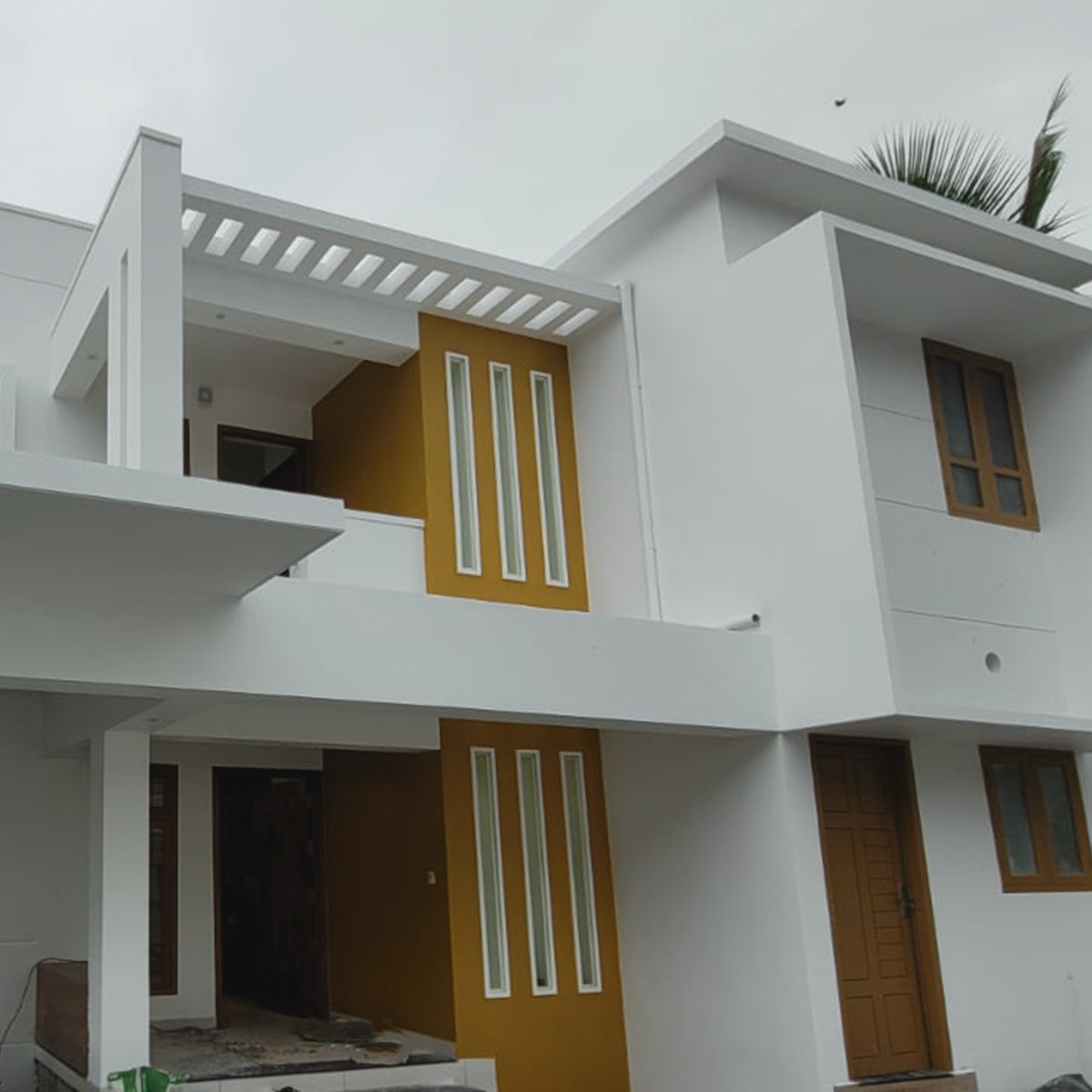 Home with mustard yellow accent facade panels